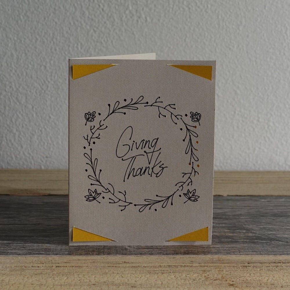 Teal card with leafs that says giving thanks