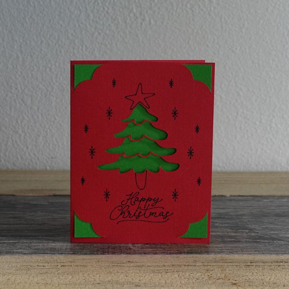Card with a christmas tree that says happy christmas